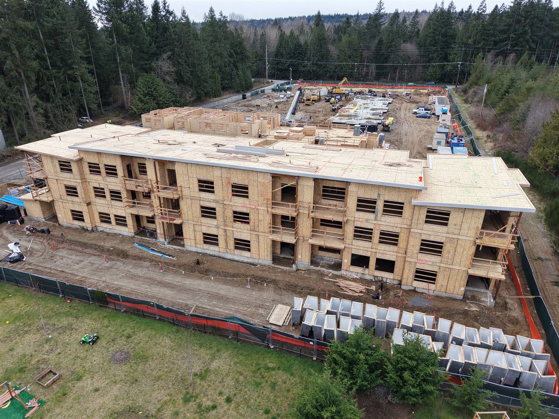 Three-story wood-frame apartment building fully framed and sheathed, aerial view